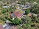 Aerial view of a fenced-in home with a screened pool and lush landscaping at 3172 Sikeston Ave, North Port, FL 34286