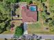 Aerial view of property, showing a screened-in pool, patio, fenced yard and mature landscaping at 3172 Sikeston Ave, North Port, FL 34286