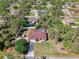Aerial shot features landscaped yard, shed, fenced in yard, pool, complemented by lush, mature trees at 3172 Sikeston Ave, North Port, FL 34286