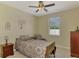 Bedroom featuring a ceiling fan, carpeted floor, and a view outside the window at 3172 Sikeston Ave, North Port, FL 34286