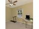 Bedroom with a ceiling fan, carpeted floor, and a treadmill next to a window at 3172 Sikeston Ave, North Port, FL 34286