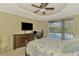 Spacious bedroom featuring a ceiling fan and sliding door to the screened pool at 3172 Sikeston Ave, North Port, FL 34286