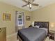 Bedroom with a dark bed frame, ceiling fan, and carpeted floor at 3172 Sikeston Ave, North Port, FL 34286