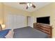 Bedroom featuring a ceiling fan, carpeted floor, closet and a dresser with television at 3172 Sikeston Ave, North Port, FL 34286
