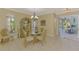 Sunlit dining room showcasing a glass table, cabinet and access to an outdoor patio at 3172 Sikeston Ave, North Port, FL 34286
