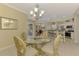 Dining room view of the kitchen and living areas featuring an elegant chandelier at 3172 Sikeston Ave, North Port, FL 34286