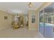 Open dining room with a glass table, cabinet, chandelier, and tiled floors at 3172 Sikeston Ave, North Port, FL 34286