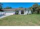 Charming single-story home with a well-manicured front lawn and arched entrance at 3172 Sikeston Ave, North Port, FL 34286