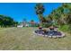 View of a lush front yard with tropical trees and decorative features at 3172 Sikeston Ave, North Port, FL 34286