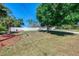 View of the home's side yard and driveway with decorative landscaping at 3172 Sikeston Ave, North Port, FL 34286
