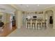 Eat-in kitchen featuring white cabinets, stainless steel appliances, and breakfast bar seating at 3172 Sikeston Ave, North Port, FL 34286