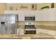 Close up shot of kitchen with stainless steel appliances and granite countertops at 3172 Sikeston Ave, North Port, FL 34286