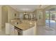 Kitchen with stone countertop bar looking to dining area and pool at 3172 Sikeston Ave, North Port, FL 34286