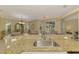 Spacious kitchen island with granite countertops, sink, and views of the dining and living areas at 3172 Sikeston Ave, North Port, FL 34286