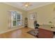Bright home office featuring hardwood floors, a large window, and a ceiling fan at 3172 Sikeston Ave, North Port, FL 34286