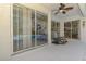 Covered patio area with ceiling fan and sliding glass doors to screened lanai and pool at 3172 Sikeston Ave, North Port, FL 34286