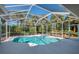 Enclosed pool and spa are surrounded by lush tropical landscaping at 3172 Sikeston Ave, North Port, FL 34286