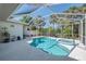 Sparkling pool and spa are surrounded by a screened enclosure and mature landscaping at 3172 Sikeston Ave, North Port, FL 34286