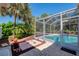 Serene screened lanai and pool area with well maintained landscaping, perfect for enjoying outdoors at 3172 Sikeston Ave, North Port, FL 34286
