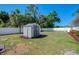 The backyard showcases a well-maintained storage shed with lush green grass and privacy fencing at 3172 Sikeston Ave, North Port, FL 34286