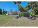 View of the home's side yard with tropical landscaping and decor at 3172 Sikeston Ave, North Port, FL 34286