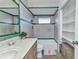 Well-lit bathroom with a tiled shower and ample storage at 3243 Elkcam Blvd, Port Charlotte, FL 33952