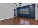 Bedroom with wood floors, window, and door at 3243 Elkcam Blvd, Port Charlotte, FL 33952