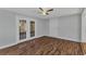 Bright bedroom featuring wood floors and glass paneled doors at 3243 Elkcam Blvd, Port Charlotte, FL 33952