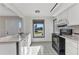 Bright kitchen featuring white cabinets, a black appliance suite, and a marble-topped peninsula at 3243 Elkcam Blvd, Port Charlotte, FL 33952