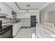 Kitchen featuring white cabinets, white marble countertops, and a black accent wall at 3243 Elkcam Blvd, Port Charlotte, FL 33952
