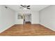 Living room featuring wood laminate flooring and an opening to another room with glass doors at 3243 Elkcam Blvd, Port Charlotte, FL 33952