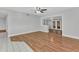 Open-concept living area with wood laminate flooring and ample natural light at 3243 Elkcam Blvd, Port Charlotte, FL 33952