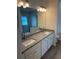 Bathroom with dual sinks, granite countertop, and white cabinetry at 383 Arbor St, Port Charlotte, FL 33953