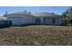 Charming single-story home featuring a well-maintained front yard and an attached two-car garage at 383 Arbor St, Port Charlotte, FL 33953