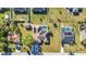 An aerial view of a home with a pool, solar panels, fenced yard, shed, trampoline, and a driveway with two cars at 3880 Pinstar Ter, North Port, FL 34287