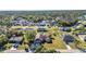 Aerial view of a residential neighborhood with well-maintained homes and lush landscaping near a lake at 3880 Pinstar Ter, North Port, FL 34287