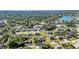 A scenic aerial shot of a residential community surrounded by lush greenery and a tranquil lake at 3880 Pinstar Ter, North Port, FL 34287