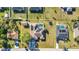 An aerial view of a home with a pool, solar panels, fenced yard, shed, trampoline, and a driveway with two cars at 3880 Pinstar Ter, North Port, FL 34287