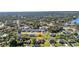 An aerial view of a neighborhood with lush greenery and various houses at 3880 Pinstar Ter, North Port, FL 34287