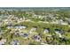 An aerial photograph of a residential neighborhood with mature trees and beautiful foliage at 3880 Pinstar Ter, North Port, FL 34287