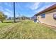 Spacious backyard with well-kept lawn, and a screened-in lanai at 3880 Pinstar Ter, North Port, FL 34287