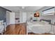 This bedroom features wood floors, a ceiling fan, and a television on the wall at 3880 Pinstar Ter, North Port, FL 34287