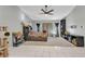 Spacious bedroom featuring a ceiling fan and carpeted area with a bed, bookcase, and table at 3880 Pinstar Ter, North Port, FL 34287