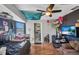 Eclectic bedroom with colorful decor, ceiling fan, and dark accent wall, creating a unique space at 3880 Pinstar Ter, North Port, FL 34287