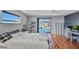 This is a bedroom with wood floors, a ceiling fan, and a view of the pool at 3880 Pinstar Ter, North Port, FL 34287