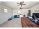 Interior of garage with two ceiling fans, air conditioner, and large desk at 3880 Pinstar Ter, North Port, FL 34287