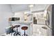 Open kitchen with breakfast bar featuring counter seating, tile floors, and stainless steel appliances for modern living at 3880 Pinstar Ter, North Port, FL 34287