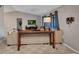 Cozy living room featuring neutral tones, plush carpeting, and a comfortable seating arrangement for relaxation at 3880 Pinstar Ter, North Port, FL 34287