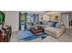 Stylish living room featuring a plush sectional, a modern coffee table, and large windows for natural light at 3880 Pinstar Ter, North Port, FL 34287