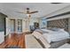 Main bedroom featuring hardwood floors, a ceiling fan, and a plush rug creating a cozy atmosphere at 3880 Pinstar Ter, North Port, FL 34287